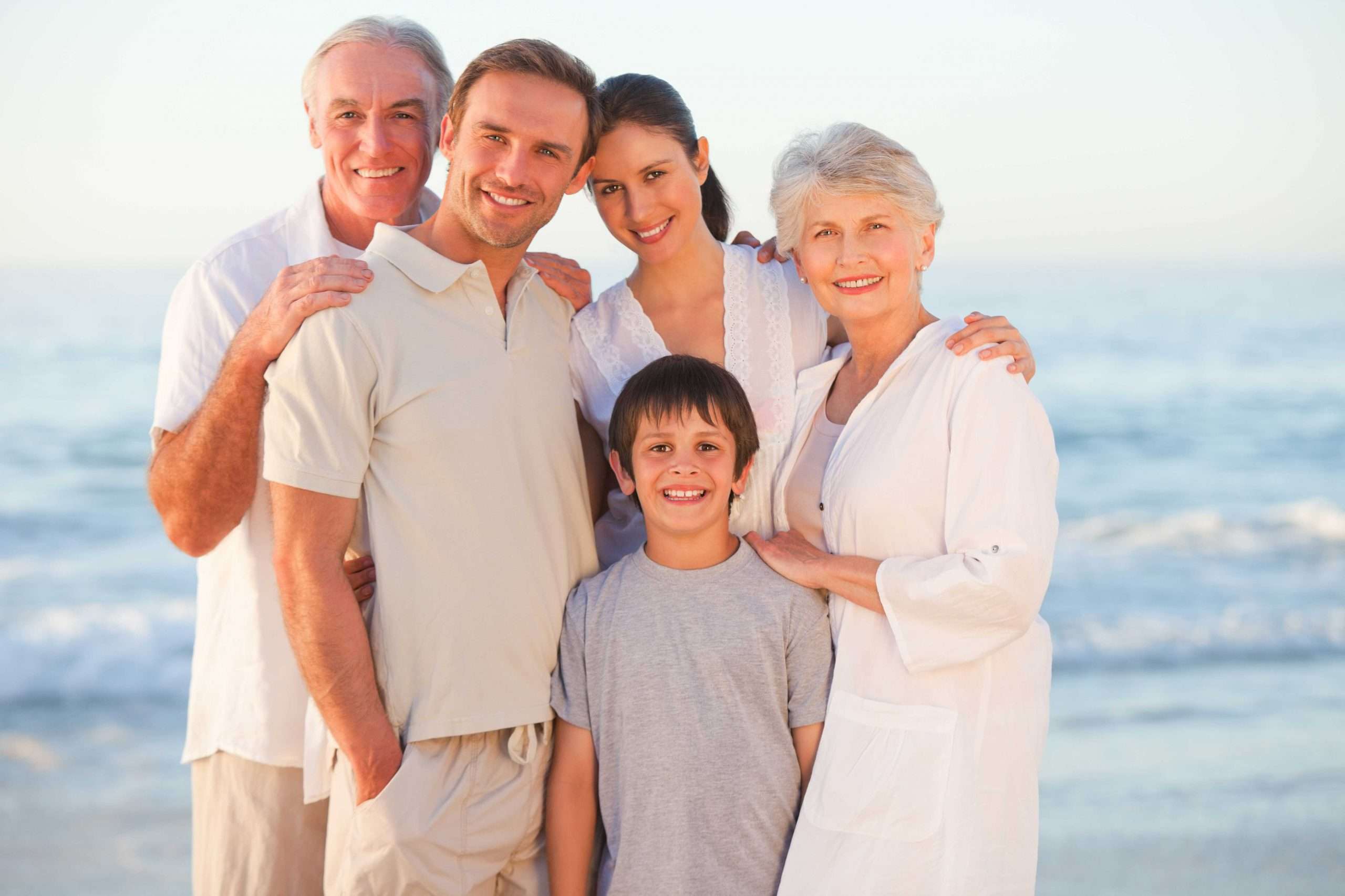 A smiling family on a beach.